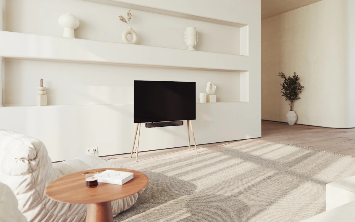 A large flat-screen television mounted above a minimalist wooden stand in a living room