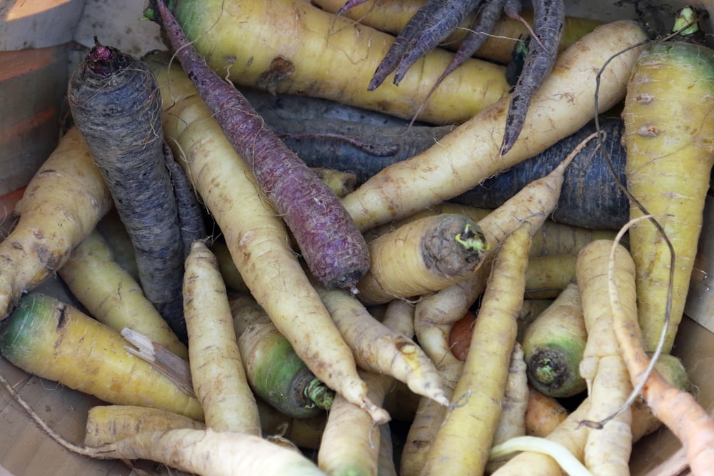 a basket filled with lots of different types of carrots