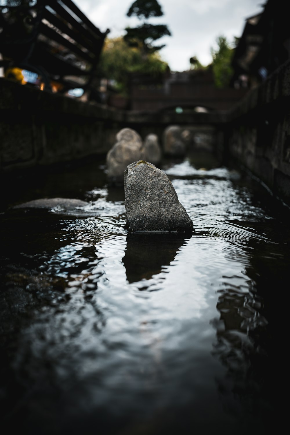 a rock in the middle of a body of water