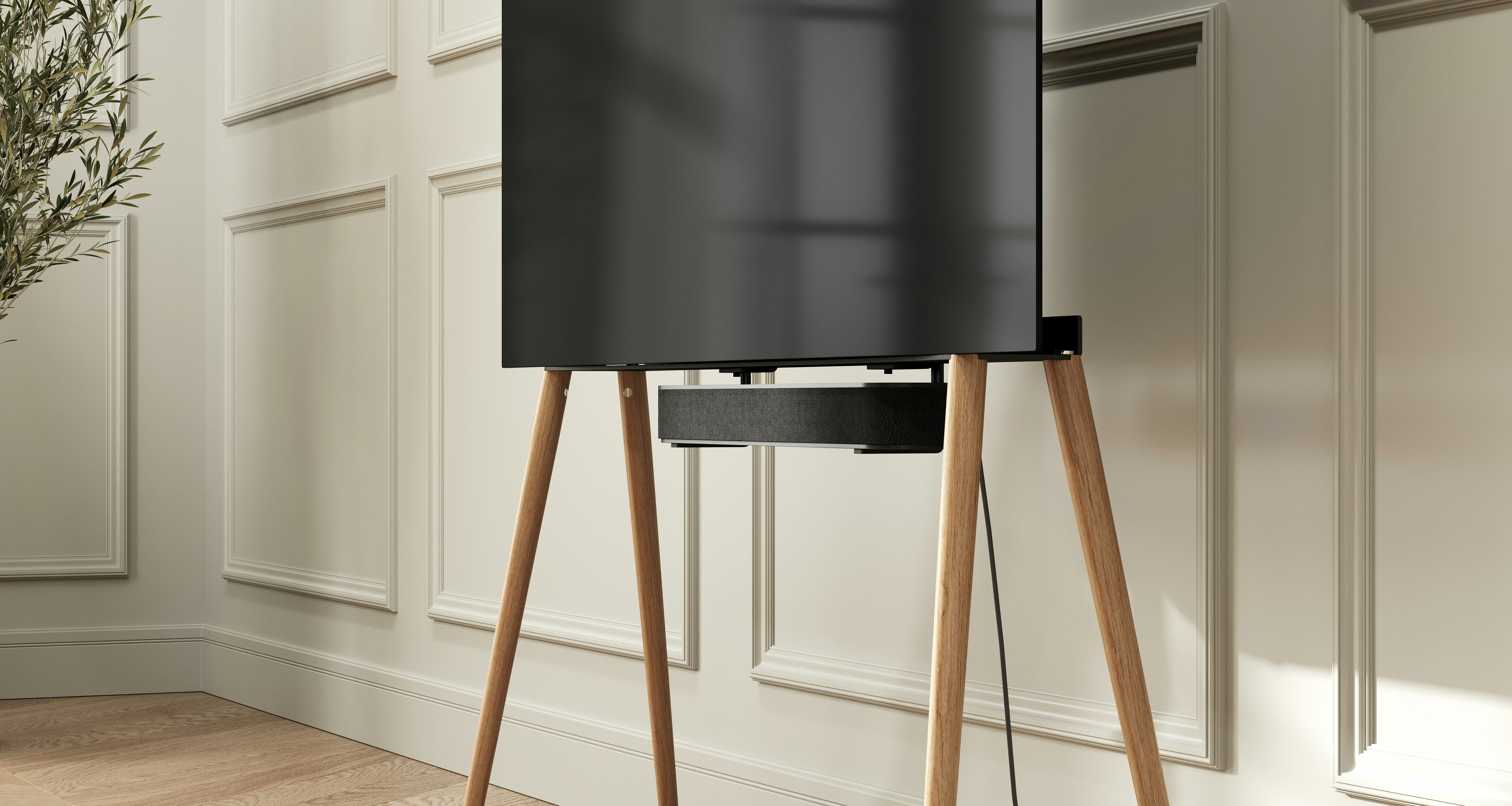a black speaker sitting on top of a wooden stand