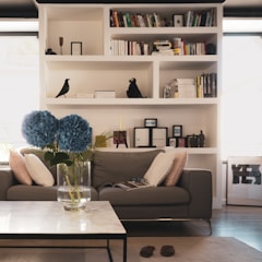 Cozy living room with freshly vacuumed carpet and dust-free shelves.