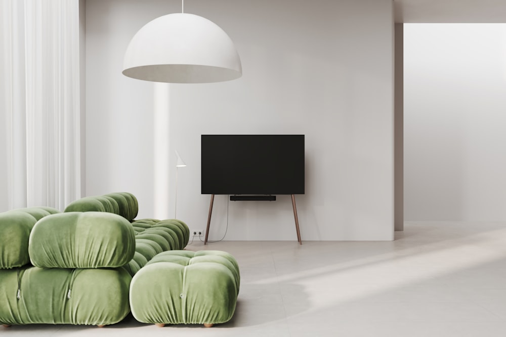 a living room with a television and a green couch