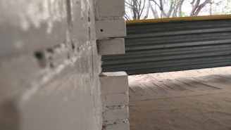 Wide shot of a partially completed masonry wall on an industrial site.