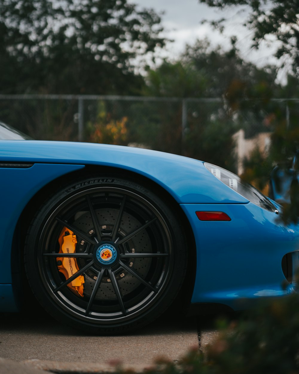 Une voiture de sport bleue garée sur le bord de la route