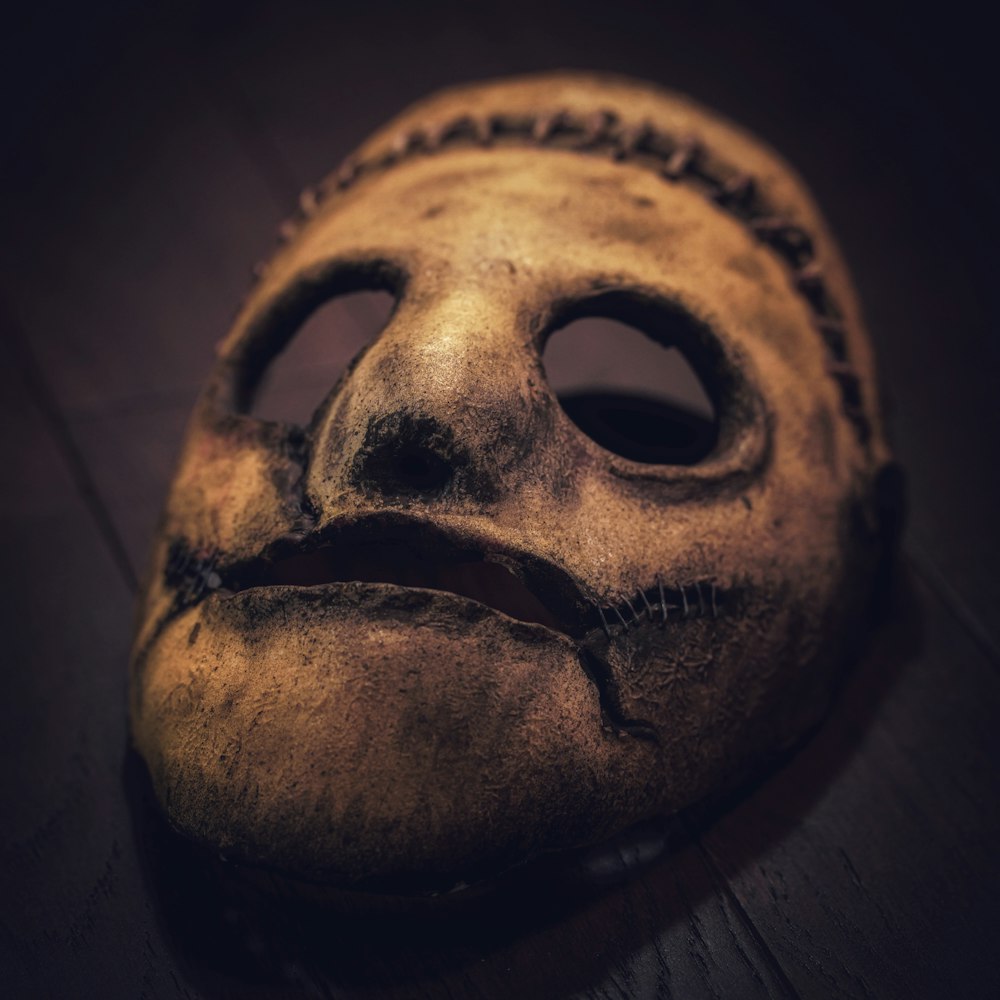 a creepy looking mask with a sad face