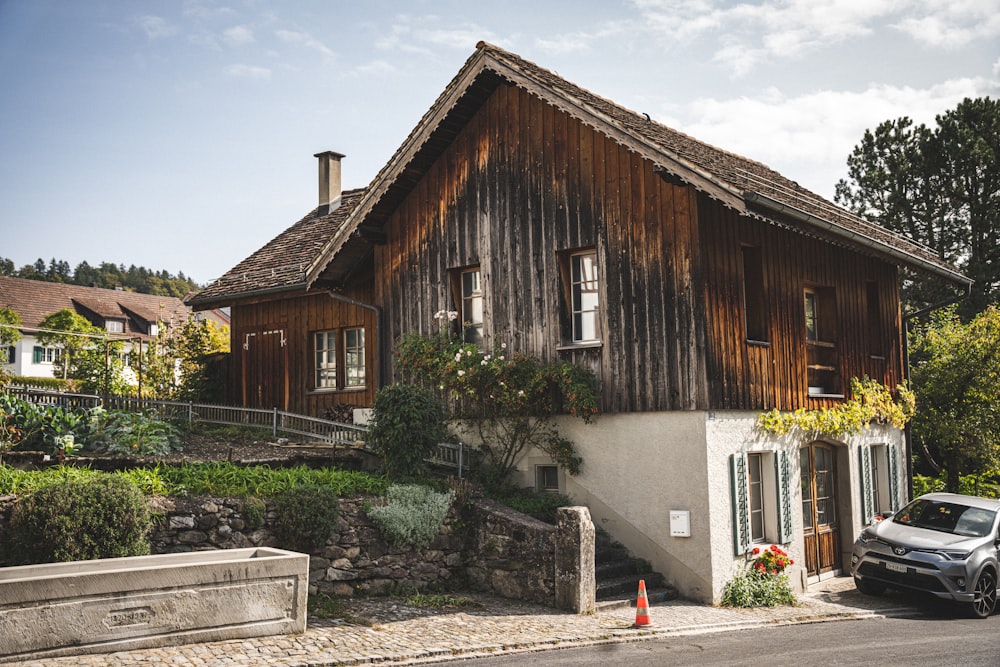 a car parked in front of a wooden house