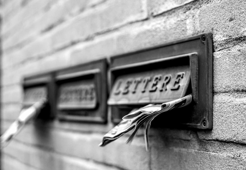 a close up of a mailbox on a brick wall