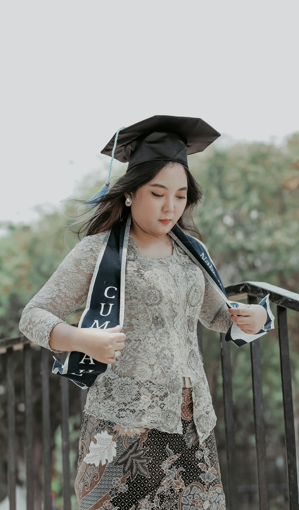 a woman wearing a graduation cap and gown