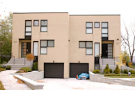 A modern duplex exterior featuring clean lines and a welcoming entrance.
