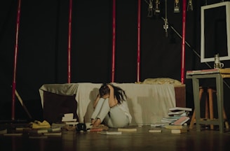 a woman sitting on the floor in front of a couch