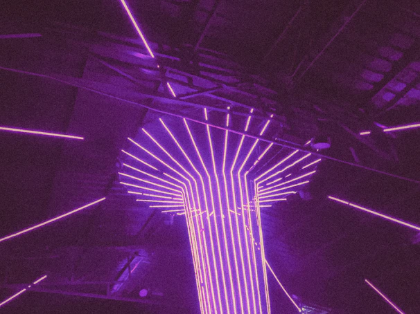 Abstract nightlife lighting installation creating a cinematic atmosphere, blending deep purple and black tones.