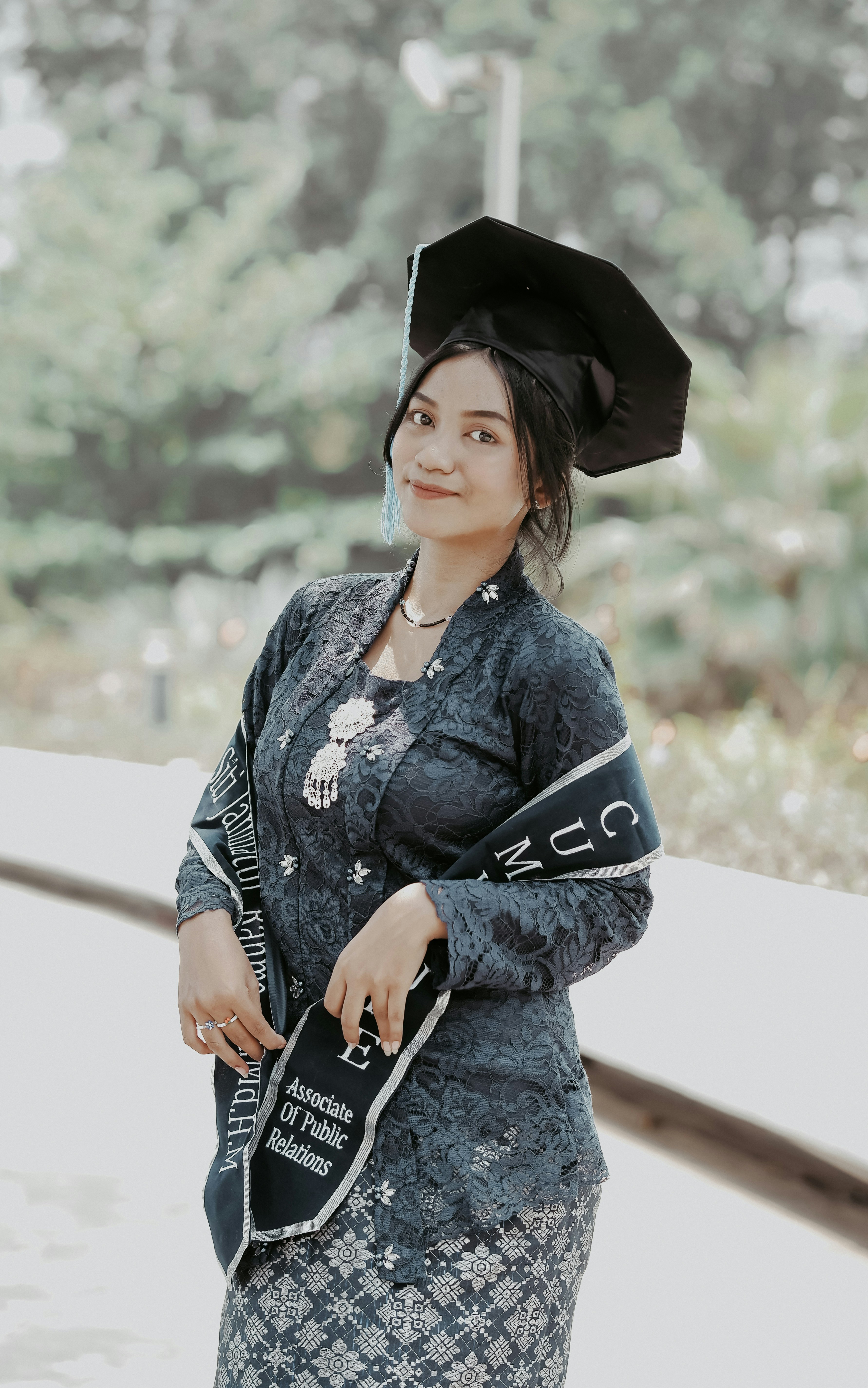 a woman in a graduation cap and gown