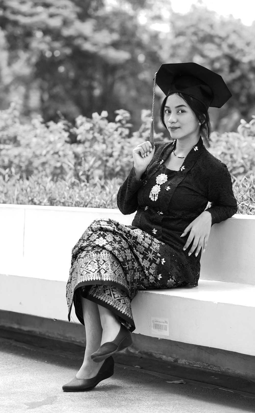 a woman sitting on a bench wearing a hat