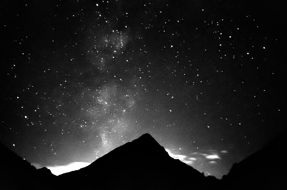 a black and white photo of the night sky