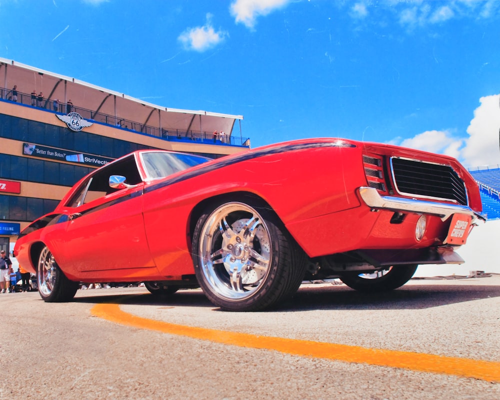 a red car parked in front of a building