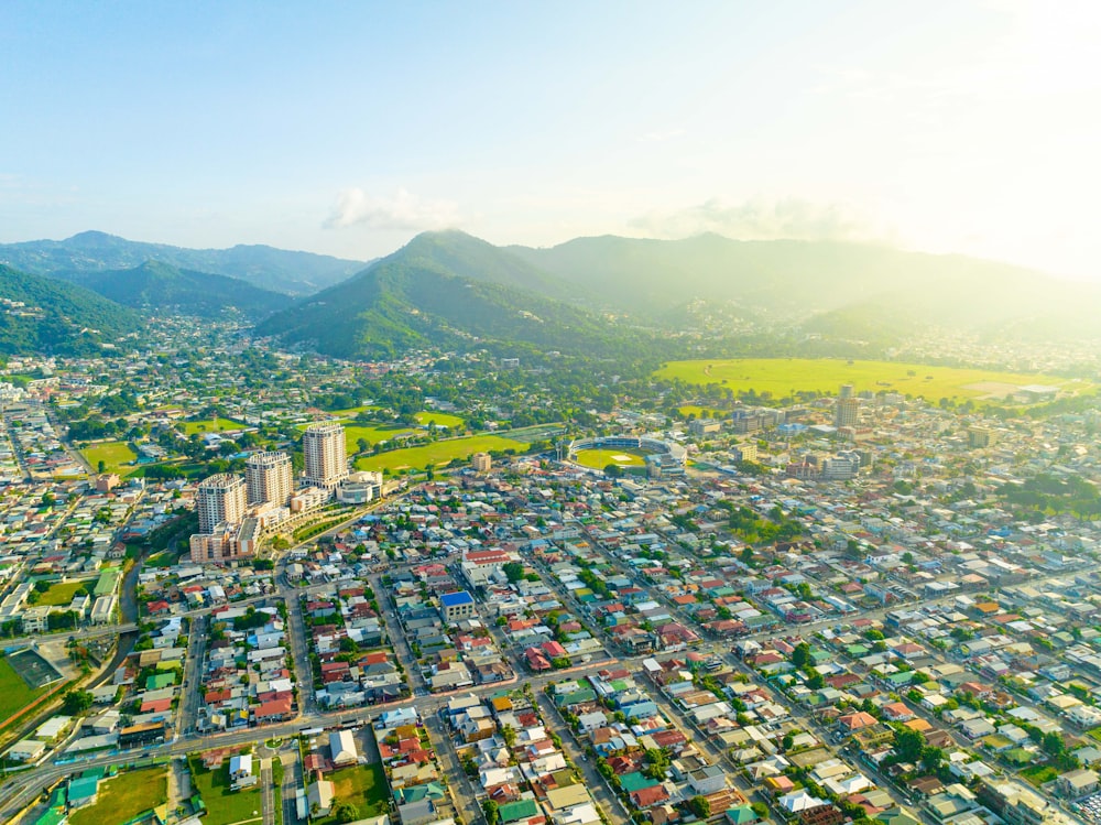 an aerial view of a city with mountains in the background