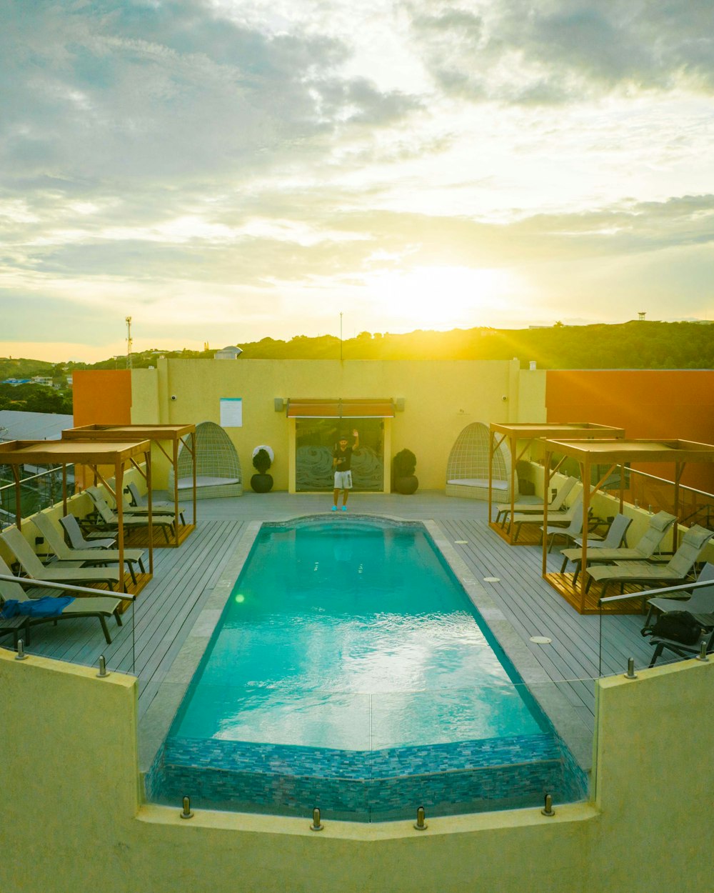 a large swimming pool with lounge chairs around it