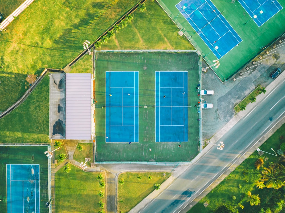 an aerial view of a tennis court in a park