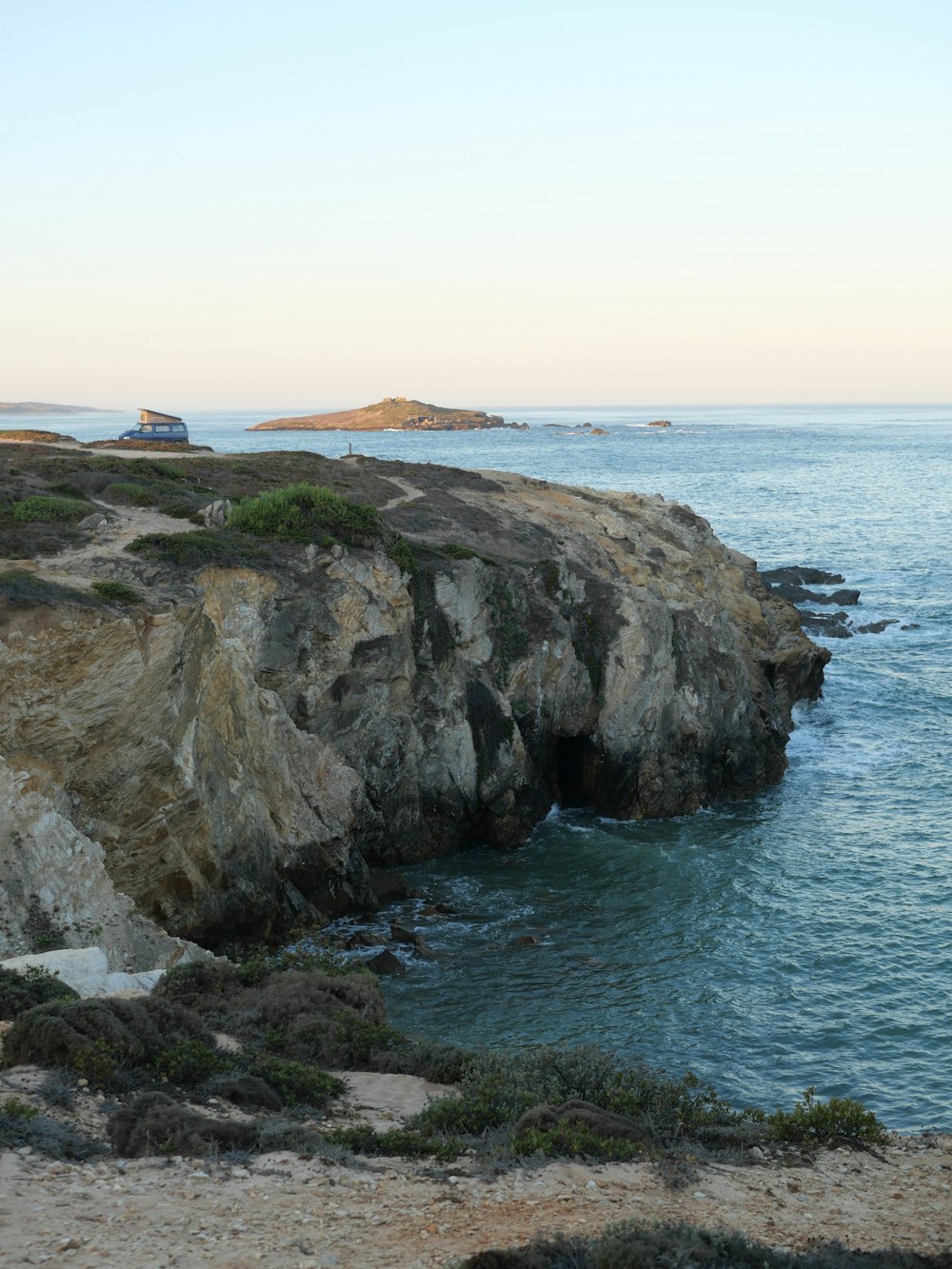 a view of a body of water near a rocky cliff