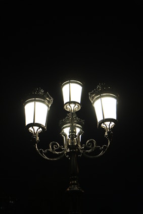 a street light with three lights on each of it's sides