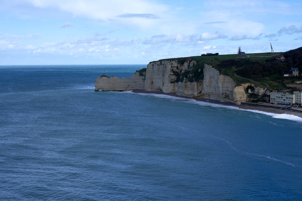 a large body of water next to a cliff