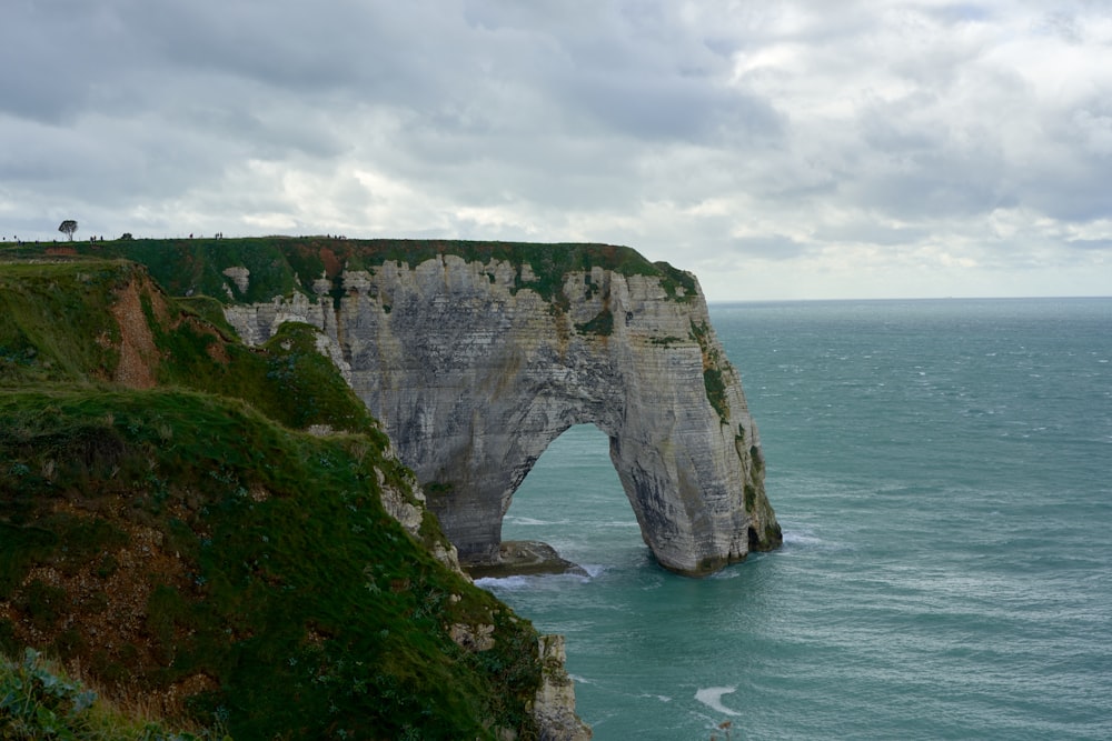 a large rock formation in the middle of the ocean