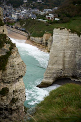A friendly consultant assisting a small business owner with digital tax software, set against a backdrop inspired by the white cliffs of Dover.