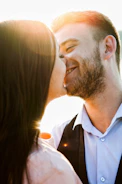 A smiling couple enjoying a romantic moment with soft focus background.