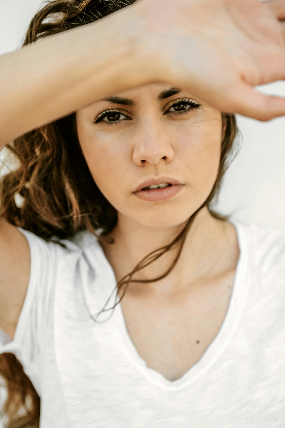 a woman with her hand on her head