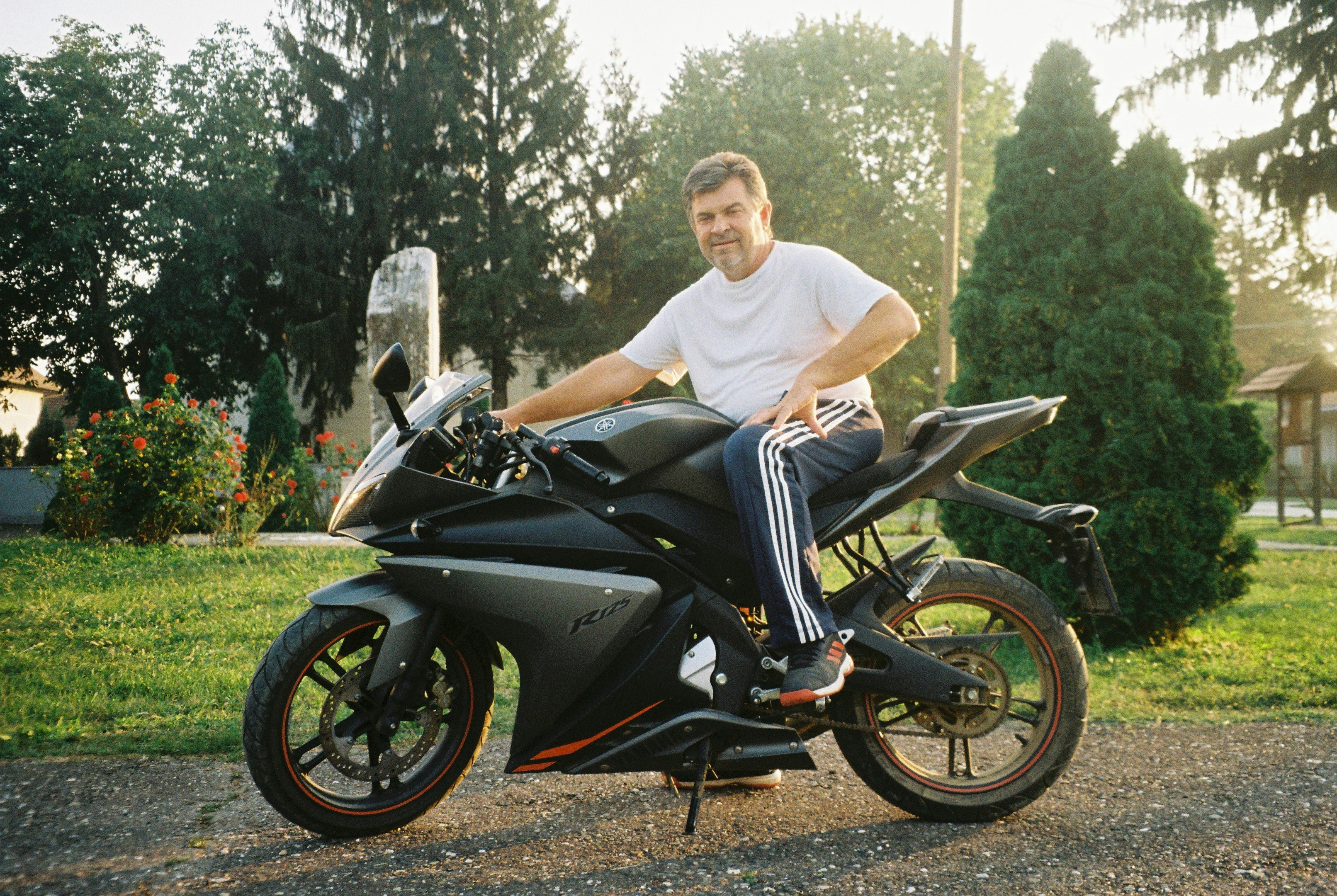 a man sitting on top of a black motorcycle