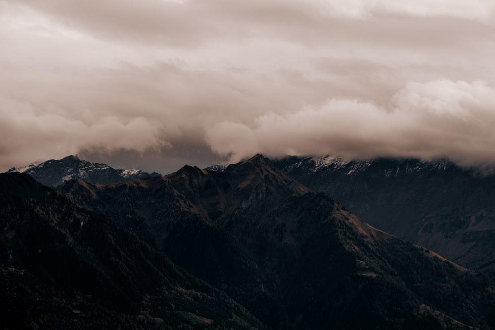 a view of a mountain range covered in clouds