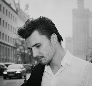 a man in a white shirt is standing on the street