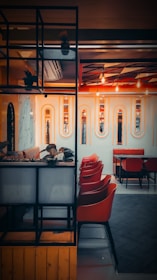 An industrial chic lounge area with geometric lighting and safety orange accents where people connect.