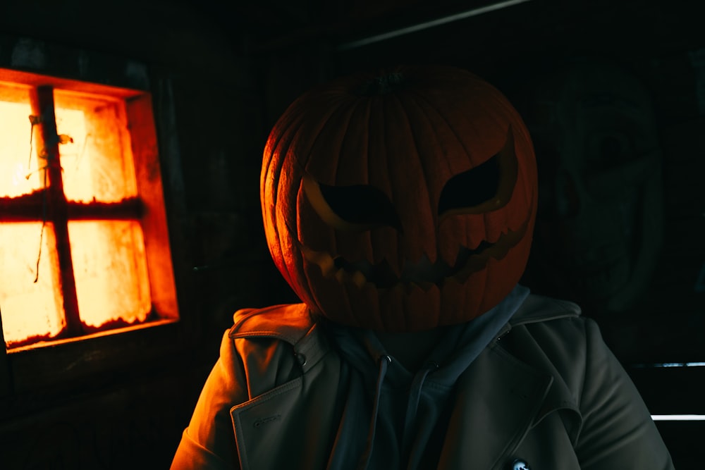 a person wearing a jack o lantern pumpkin mask