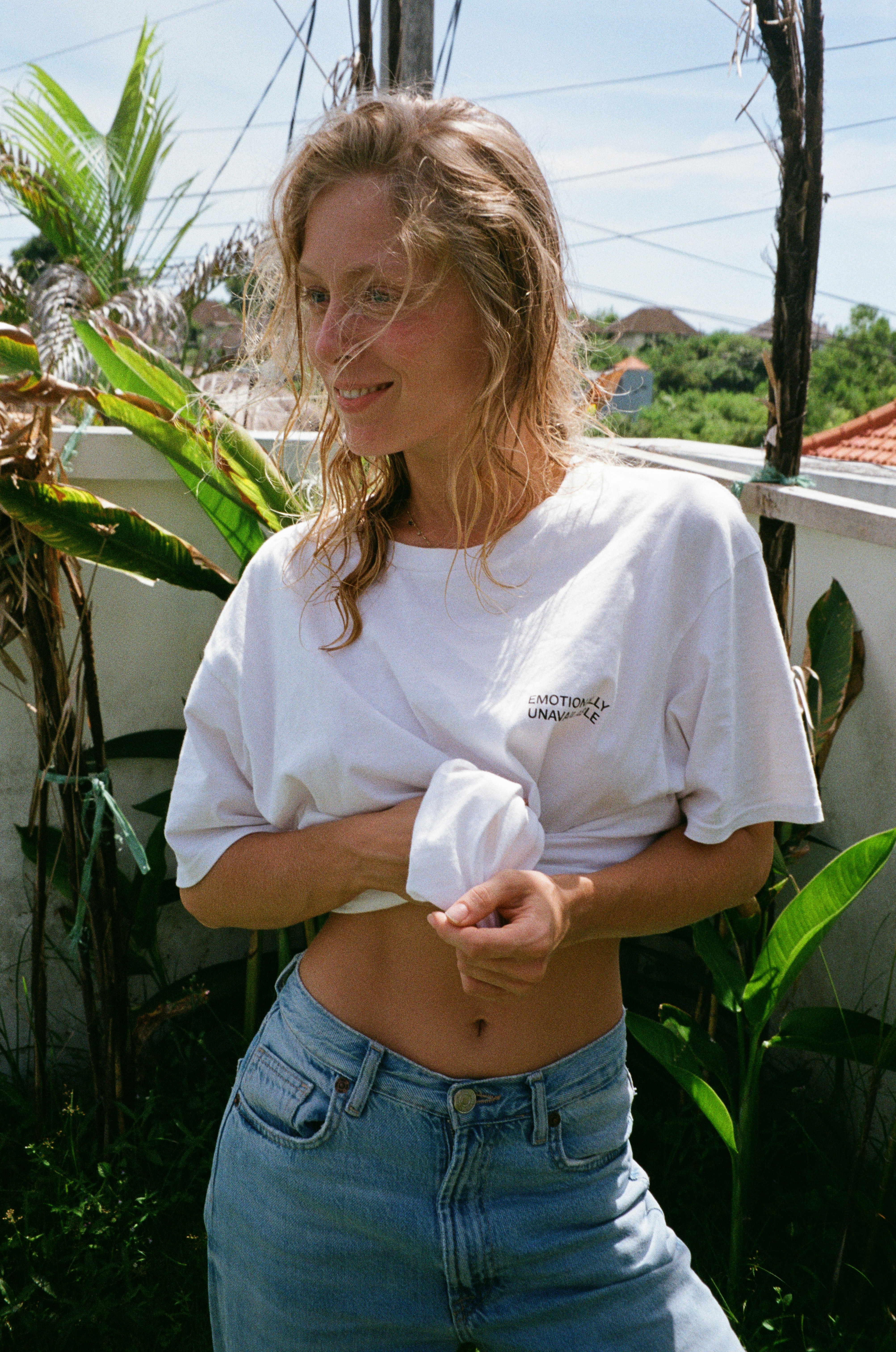 a woman wearing a white shirt and jeans