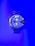 A large wristwatch with a metallic strap is displayed against a vibrant blue background. The watch face is detailed with multiple dials and has a bold design. The watch brand 'Diesel' is visible on the right side of the watch face.