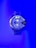 A large wristwatch with a metallic strap is displayed against a vibrant blue background. The watch face is detailed with multiple dials and has a bold design. The watch brand 'Diesel' is visible on the right side of the watch face.