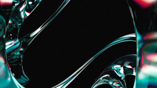 Fluid, metallic-like structures with a shiny surface swirl and curve against a dark background. The surfaces reflect light in a gradient of colors, giving an impression of movement and fluidity.