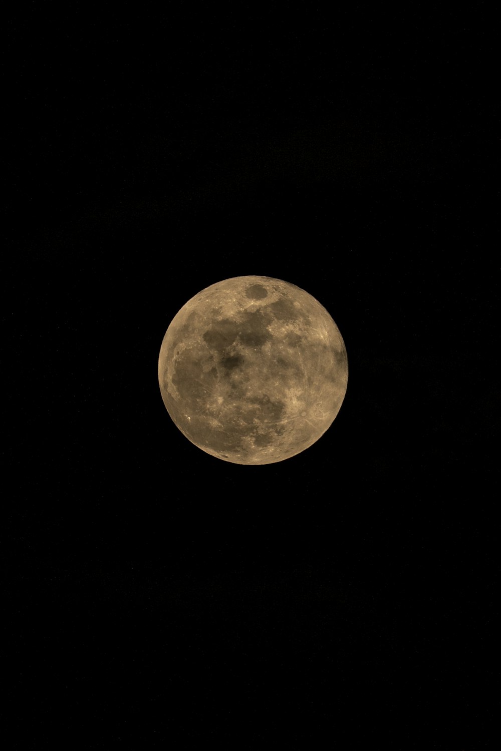 a full moon is seen in the dark sky