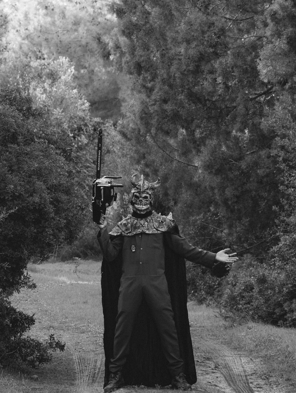 a man in a costume is standing on a dirt road
