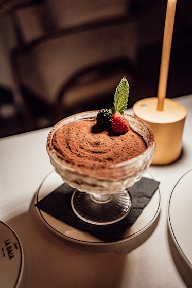 a dessert dish with a strawberries on top of it