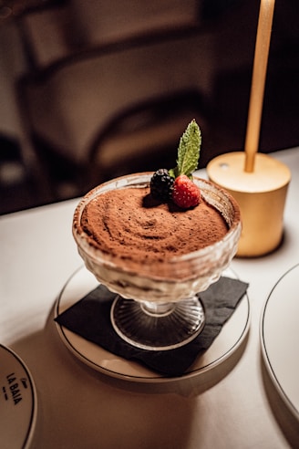 a dessert dish with a strawberries on top of it