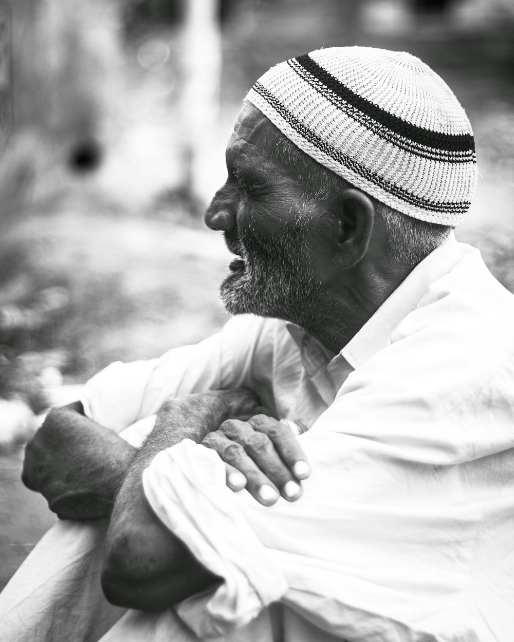 a black and white photo of a man with a hat