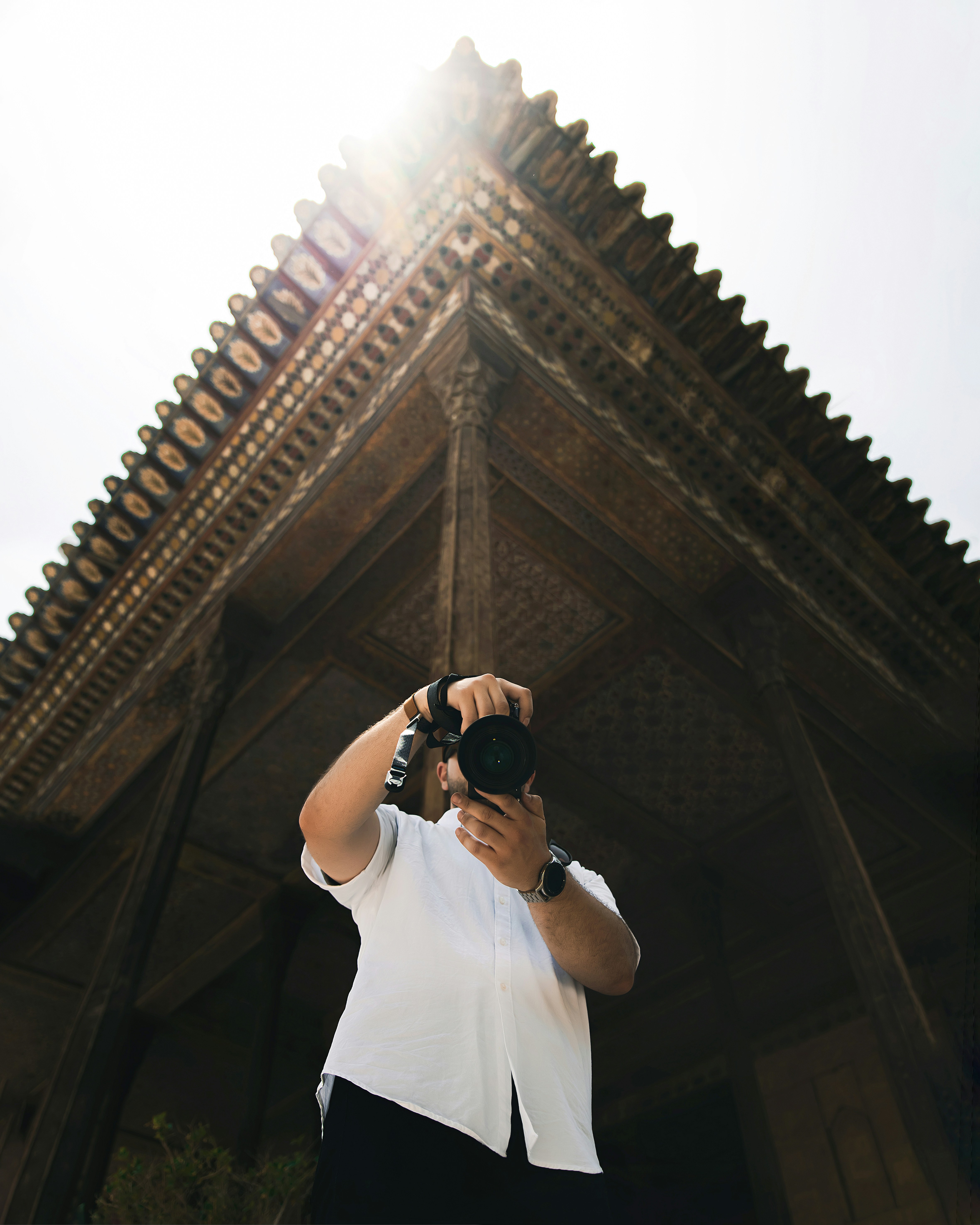 a man taking a picture of a building with a camera