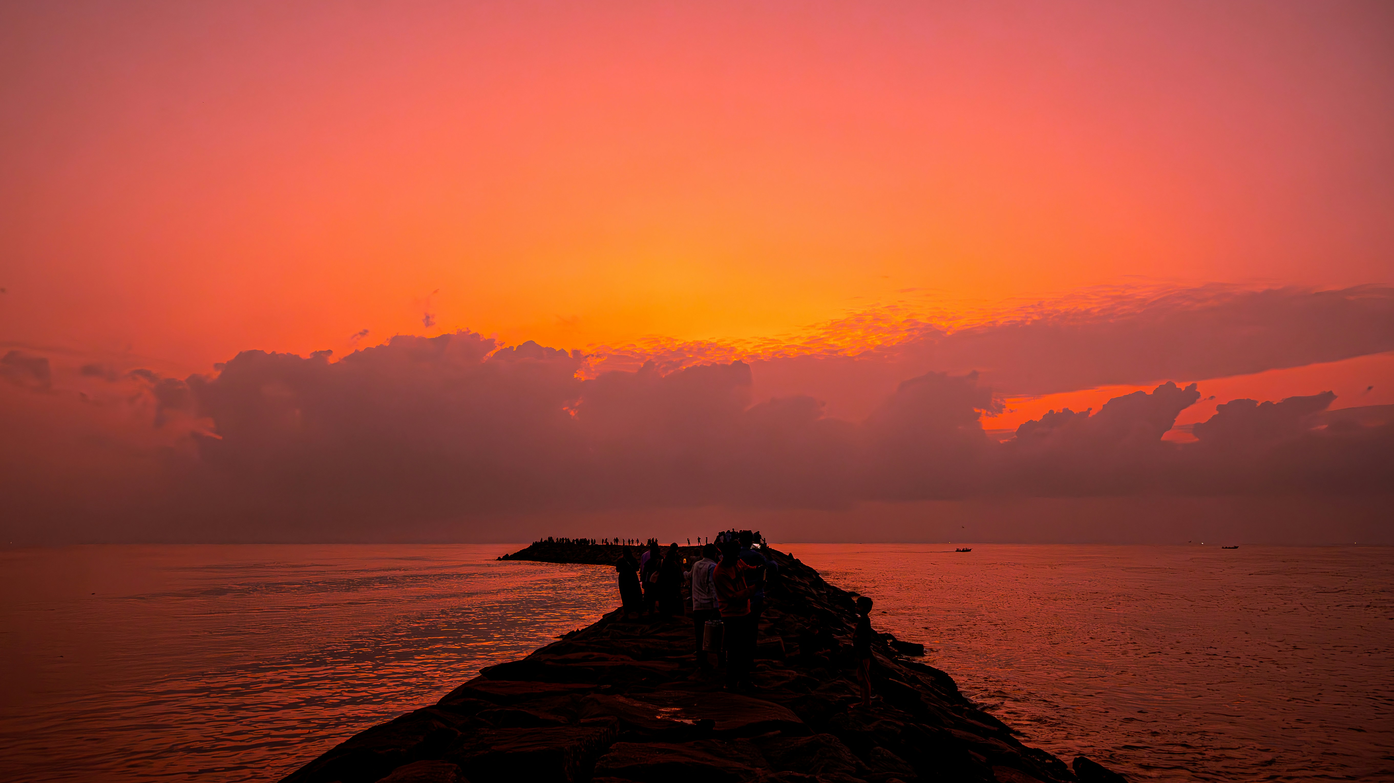 a group of people standing on top of a pier
