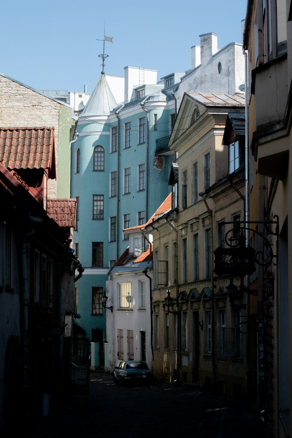 a narrow city street with several buildings on both sides