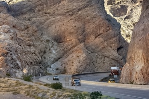 A winding highway through a vibrant canyon landscape.