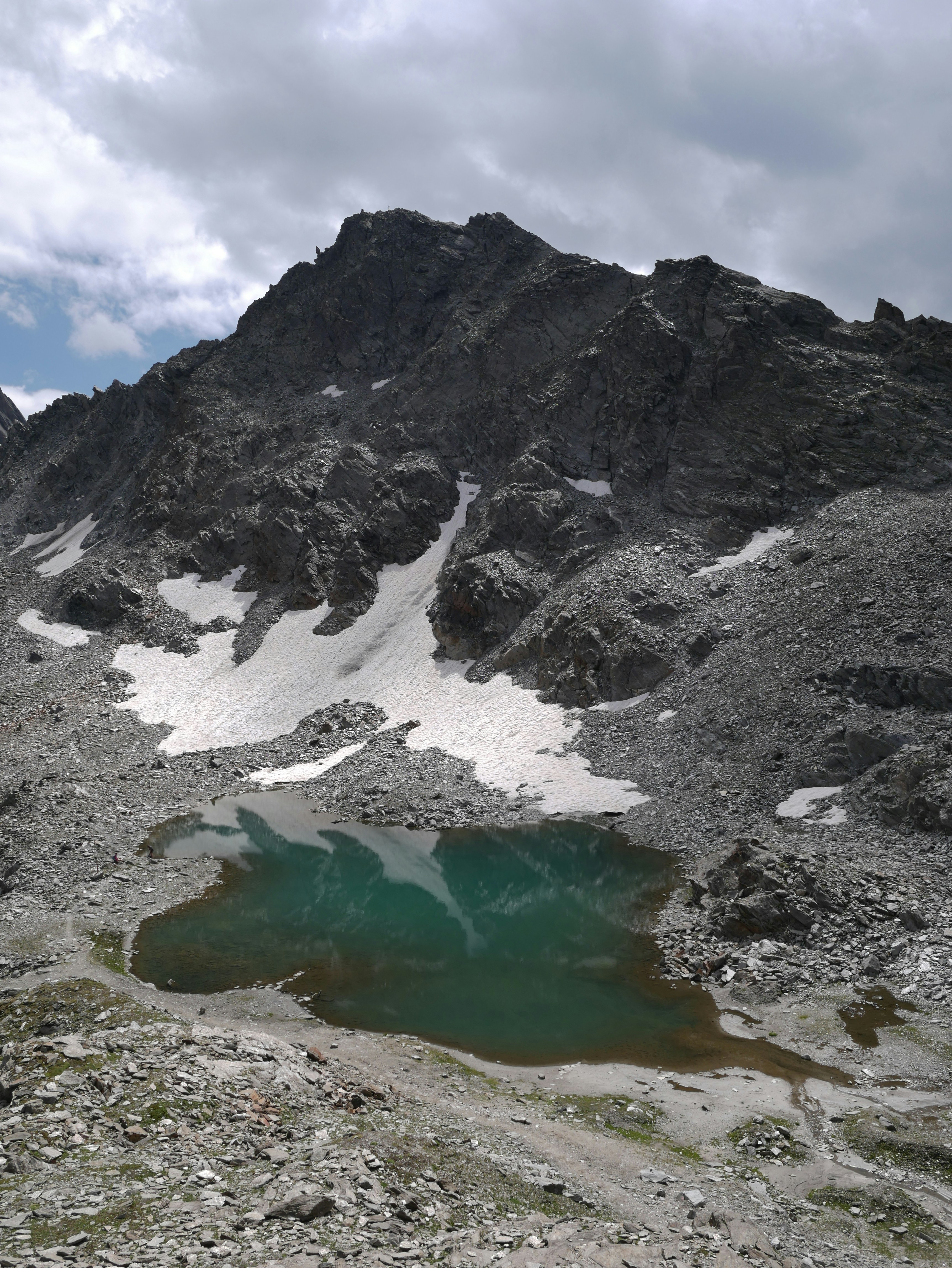 a mountain with a lake in the middle of it