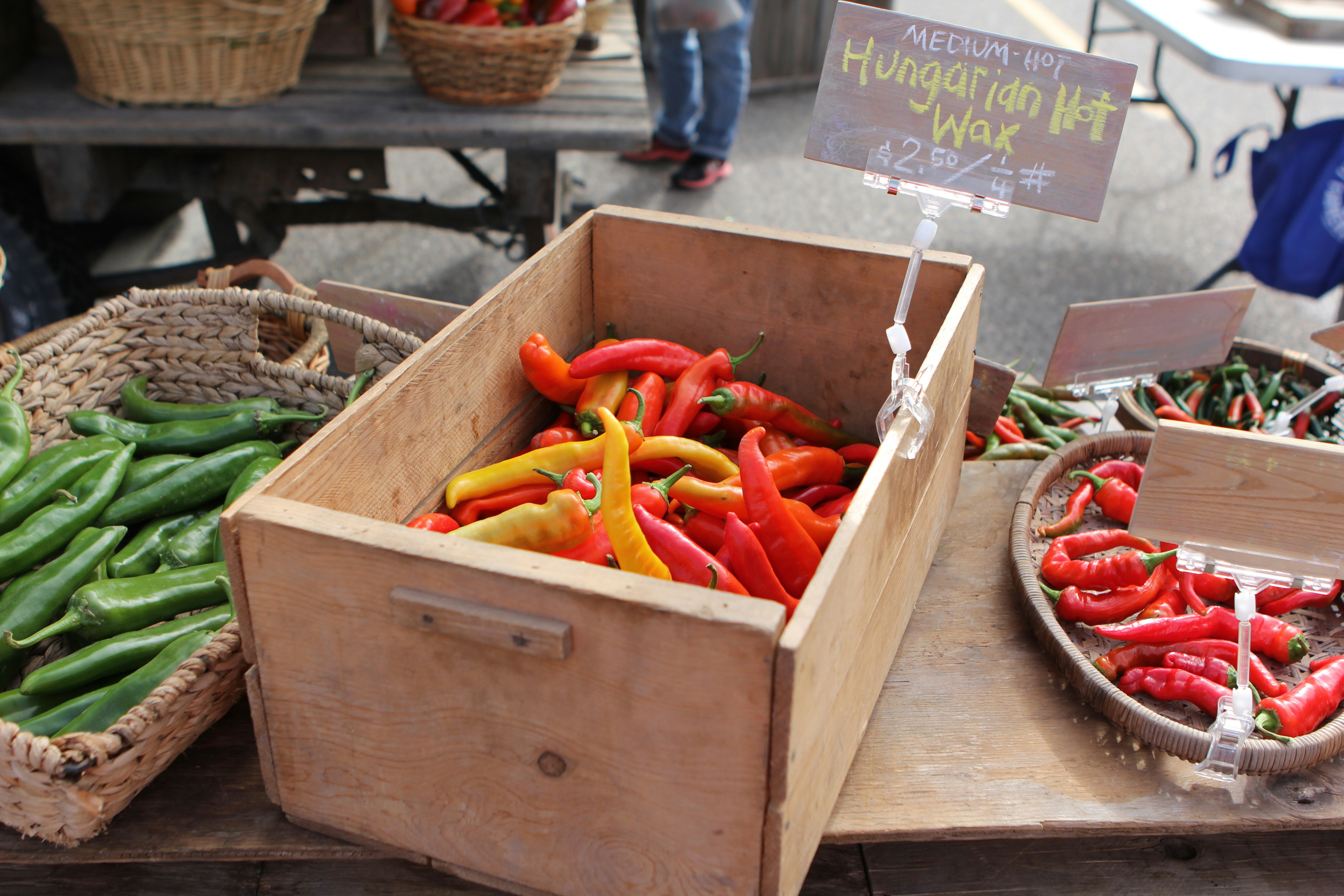 a wooden box filled with lots of red and green peppers, Vegetables sold at the Pocatello, Idaho, farmer