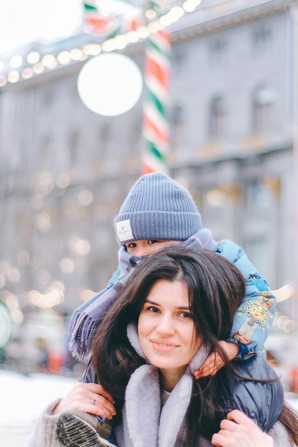 a woman is carrying a child on her back